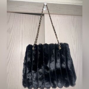 Fuzzy black purse with gold metallic shoulder strap